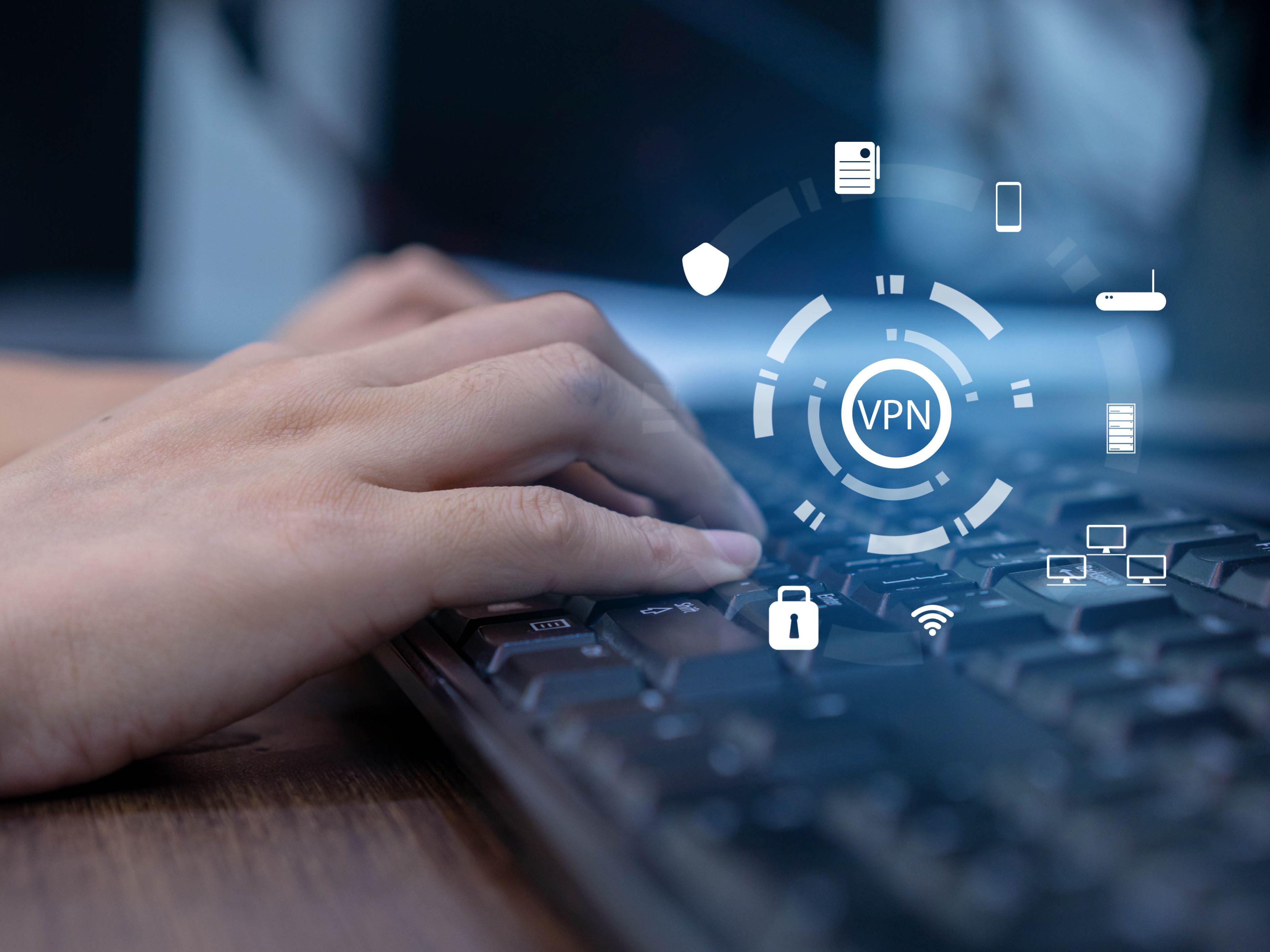 Person typing on computer with VPN graphics