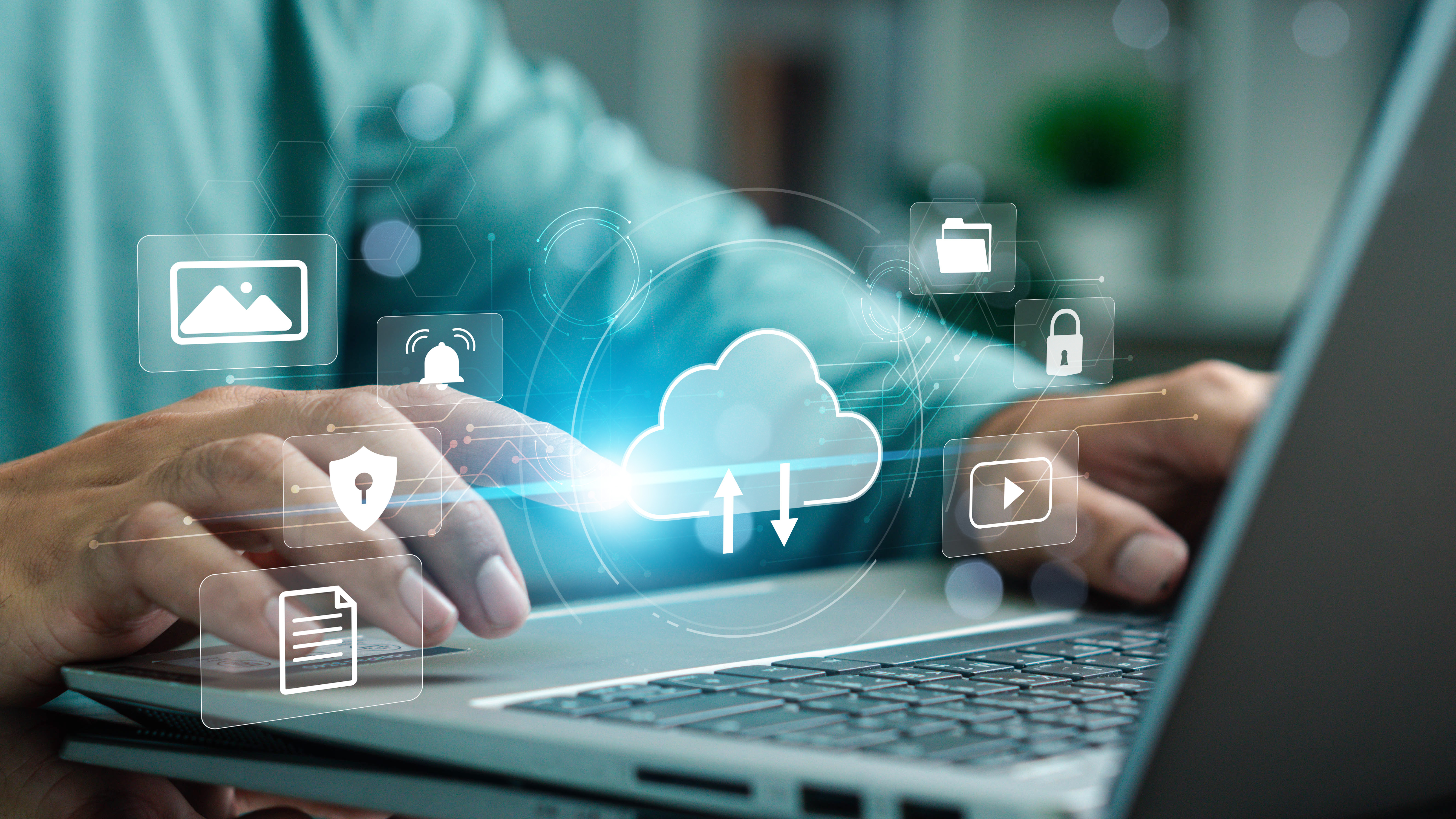 Person on laptop with holographic elements with a cloud backup symbol