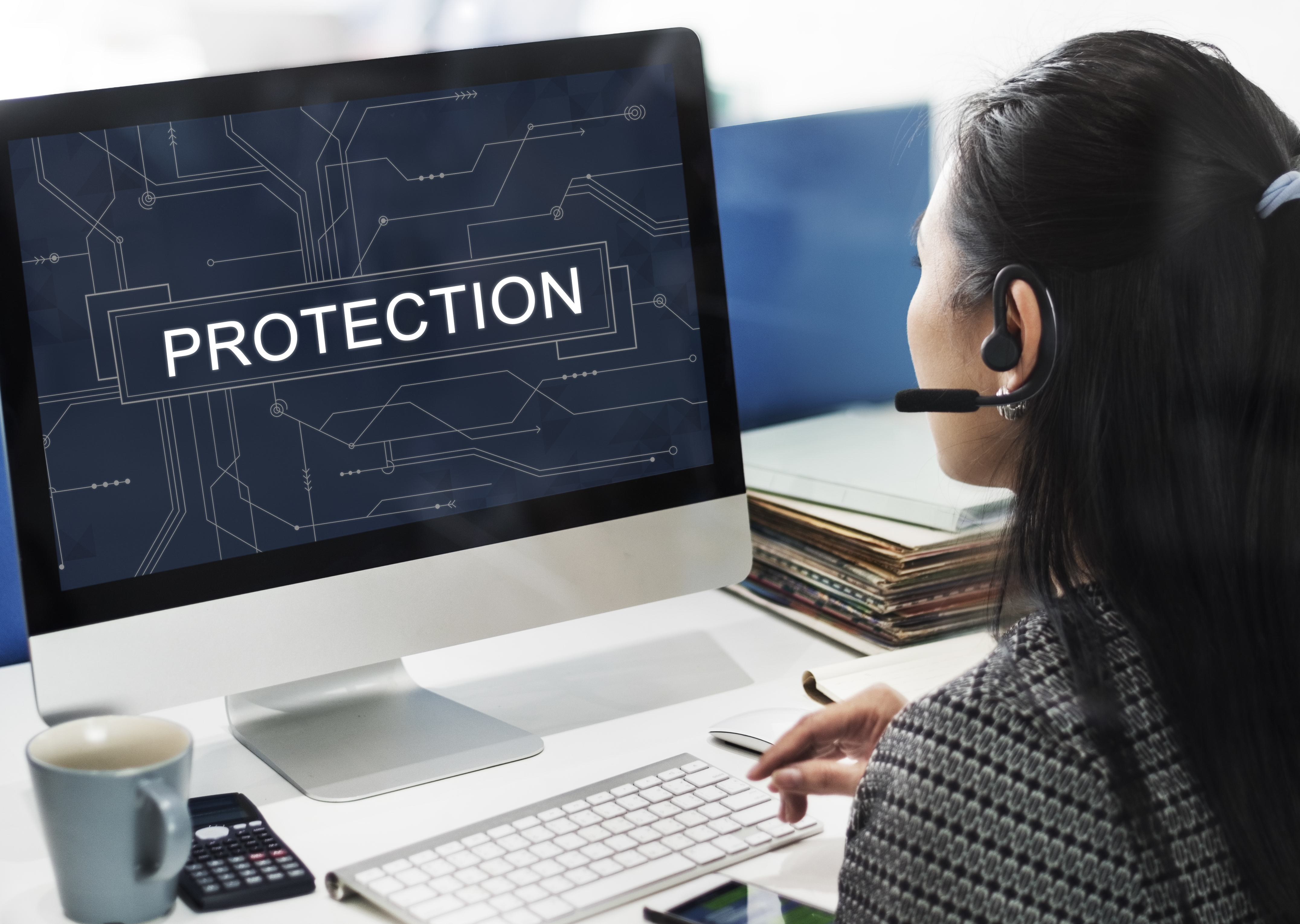 Woman looking at laptop that says "protection" on it.
